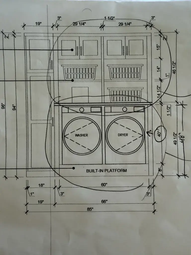 A dimensioned millwork elevation for a laundry room, marked up by hand during a drawing review